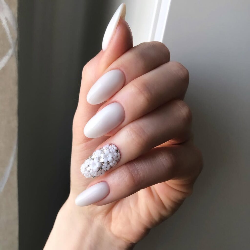 Milky White Nails with delicate floral nail art - a fresh spring manicure featuring soft white polish and minimalist flower designs