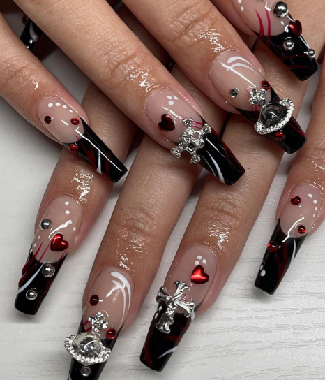 Dark red nails adorned with rhinestone details for a glamorous and eye-catching design.